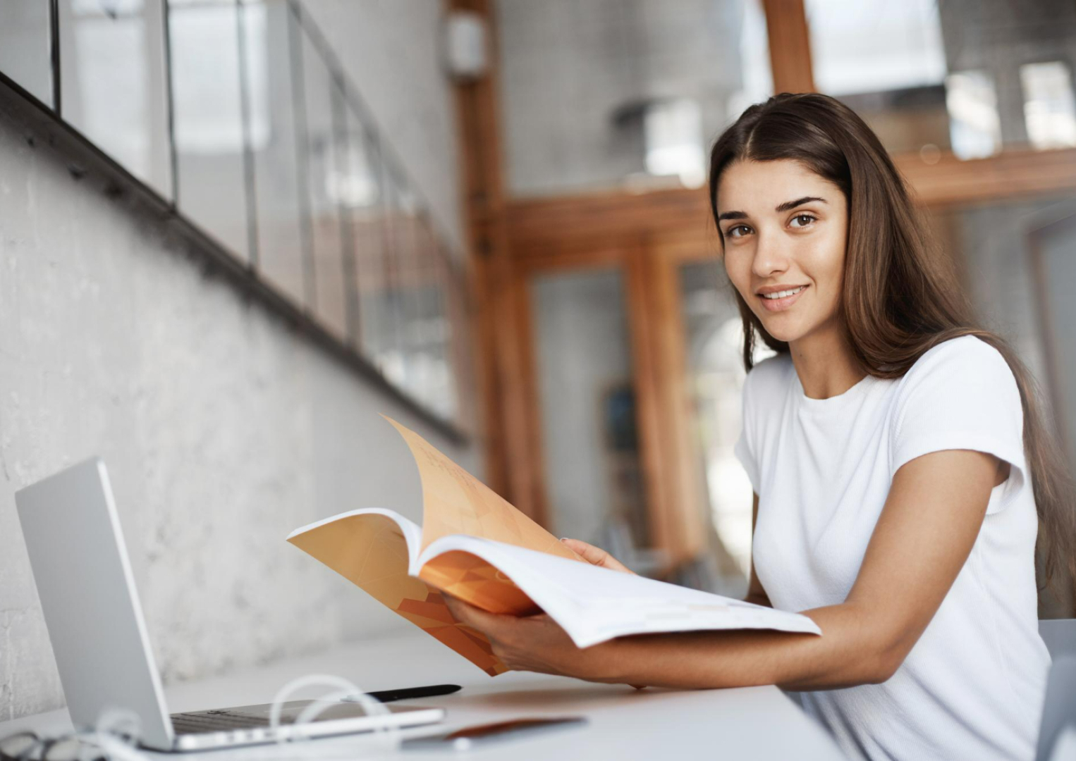 beautiful-young-student-preparing-her-english-exams-university-campus-using-laptop-handbook-education-concept